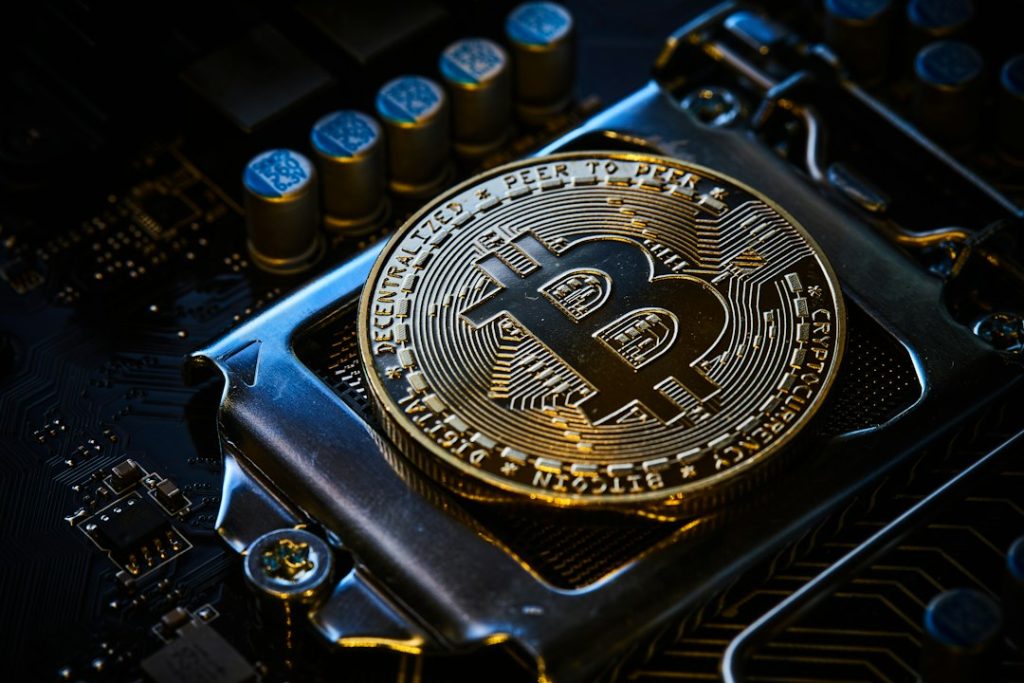 Bitcoin token on computer hardware for NetNapz Academy Bitcoin supply and mining guide. Photo by Michael Förtsch via Unsplash.