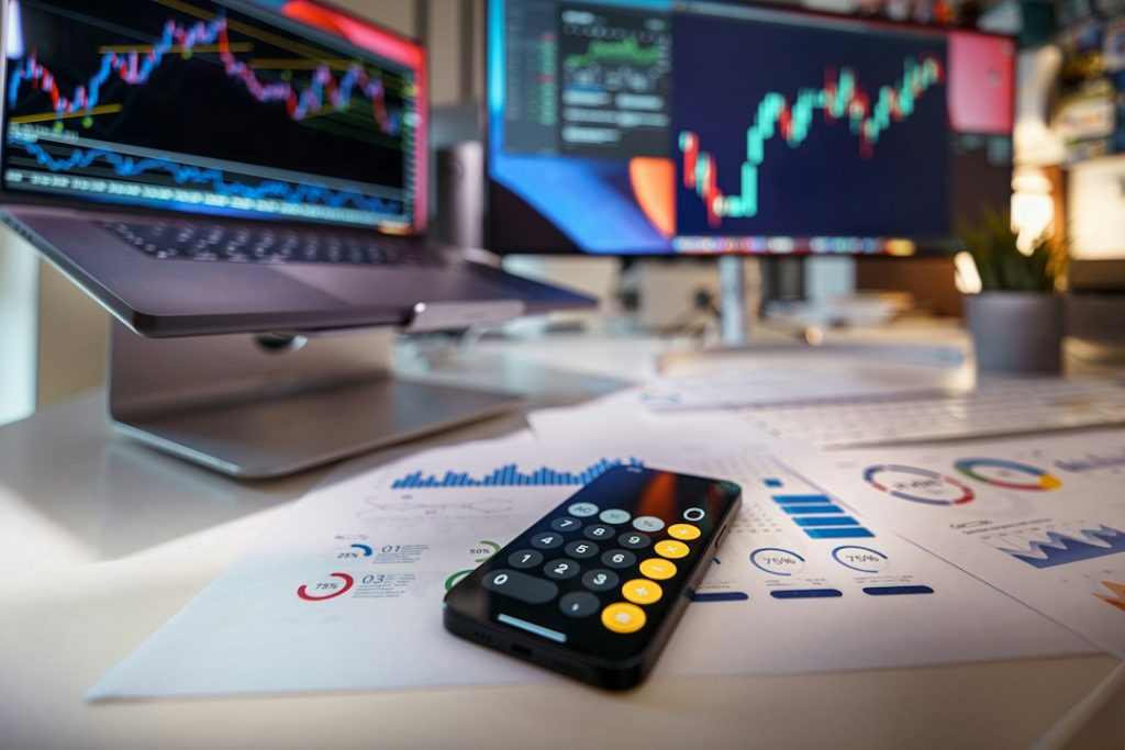 Finance calculator and market materials for NetNapz Academy crypto risk management guide. Photo by Jakub Żerdzicki via Unsplash.