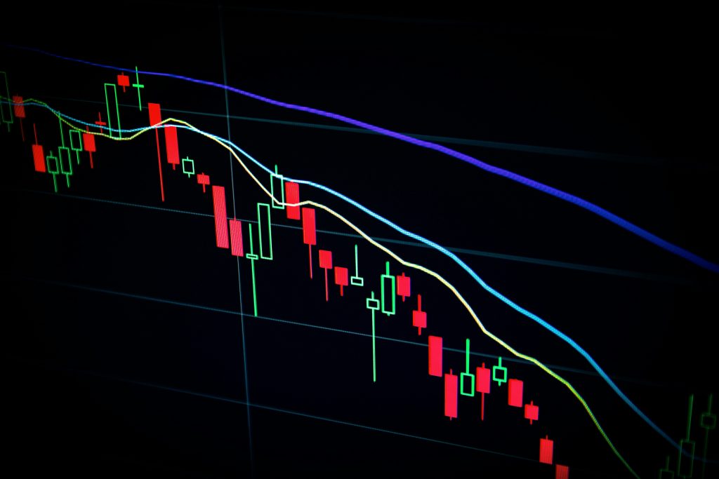 Falling candlestick chart on a dark trading screen