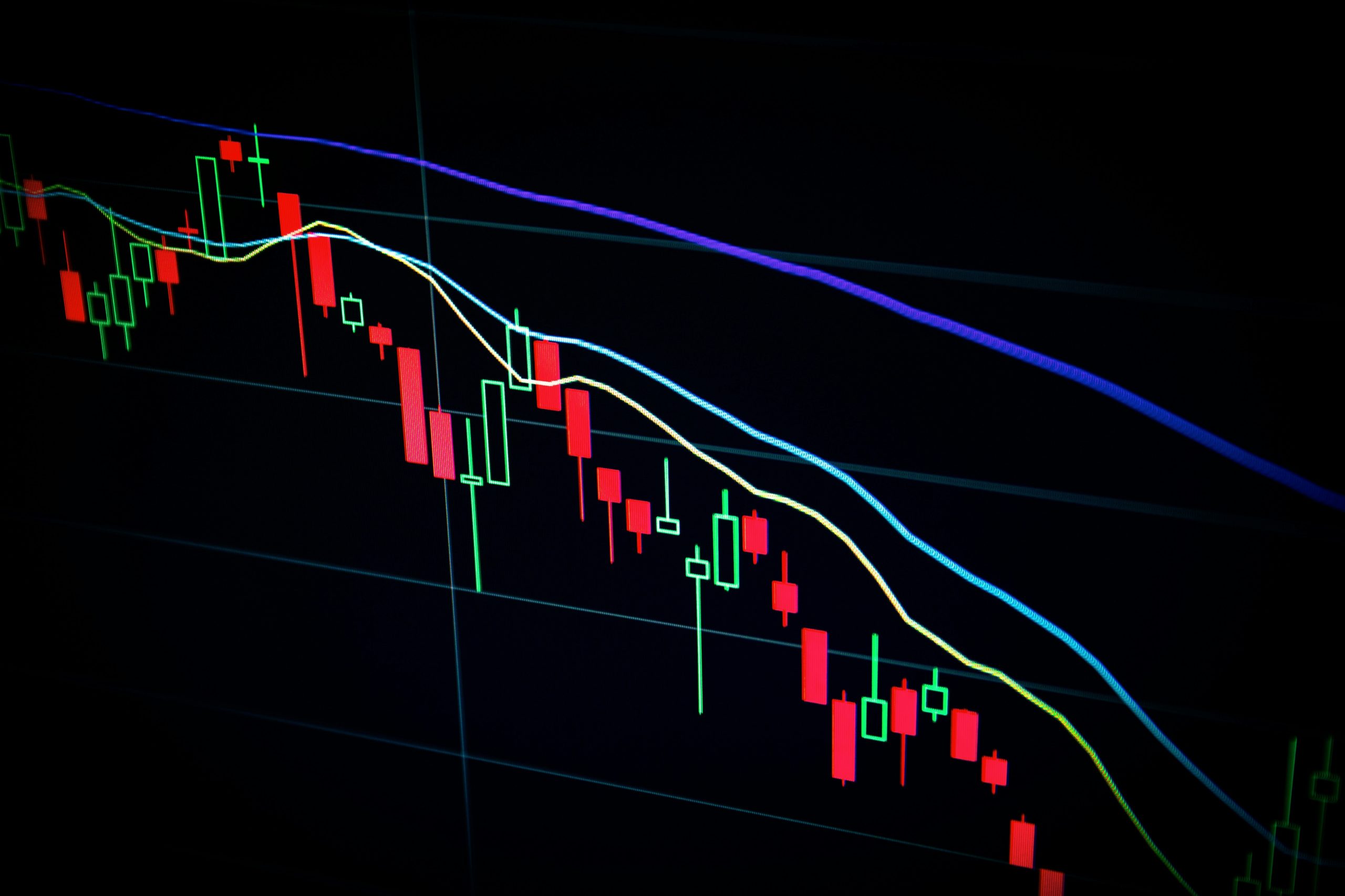 Falling candlestick chart on a dark trading screen