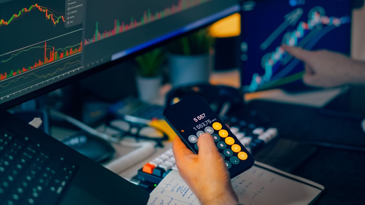 Financial analysis desk with technology and market charts