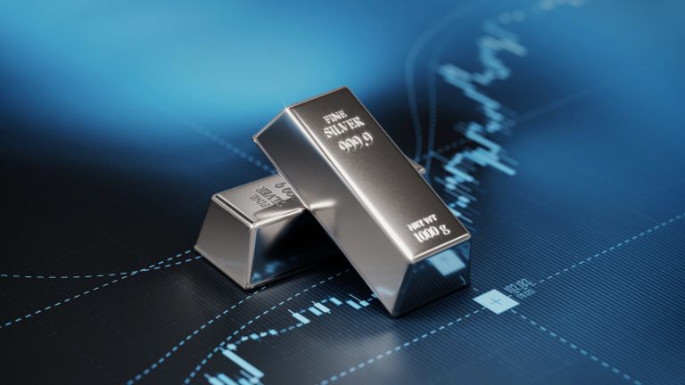 Silver bullion bars over a financial market chart