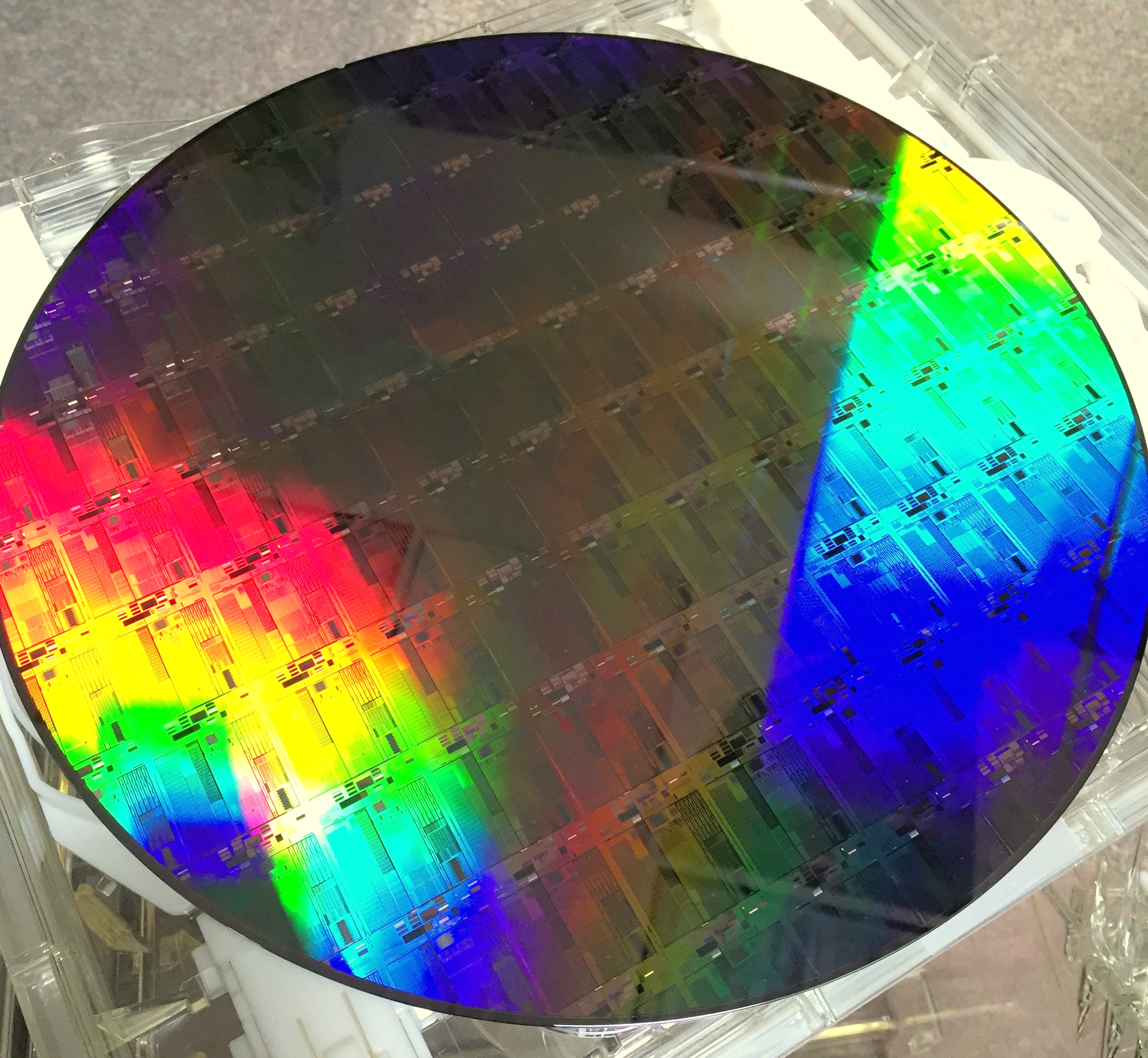 Silicon photonics wafer representing AI data-centre optical interconnect demand