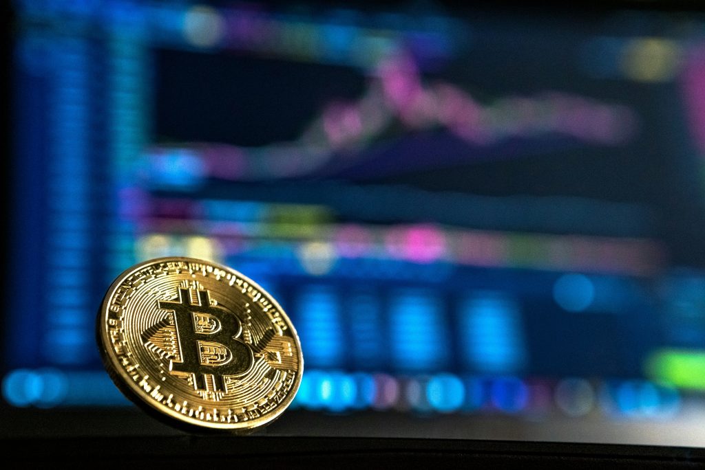 Bitcoin coin against a digital market chart background