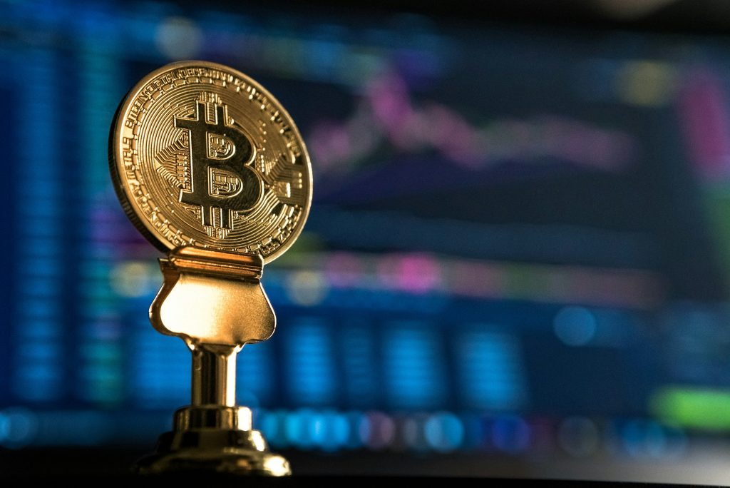 Bitcoin coin displayed above a market chart