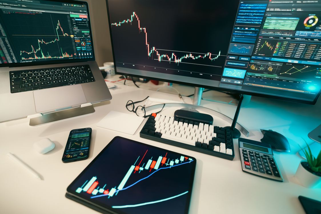 Trading desk with multiple financial market charts