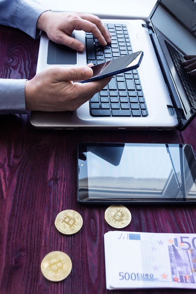 Computer, smartphone, cash and physical bitcoin tokens for NetNapz crypto-mining and illicit-finance coverage