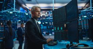 Financial analyst at a multi-monitor market workstation for NetNapz market analysis