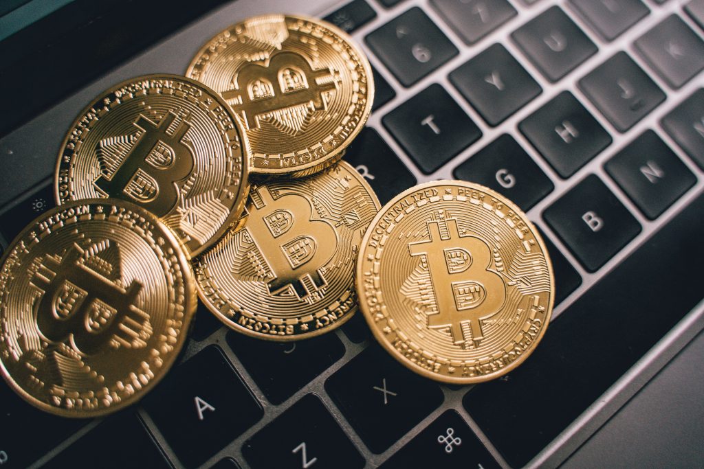 Cryptocurrency coins on a laptop representing stablecoin reserve verification